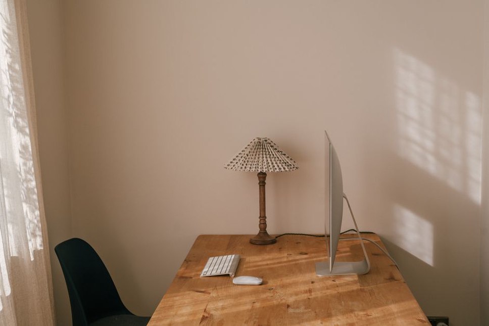 Feet supported beneath a home office desk