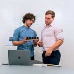 Engineers checking organizational details on a laptop