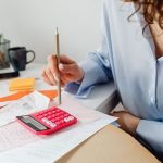 Bank records beside a draft monthly spending plan