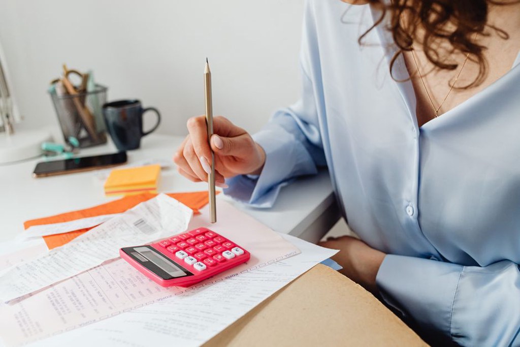 Bank records beside a draft monthly spending plan
