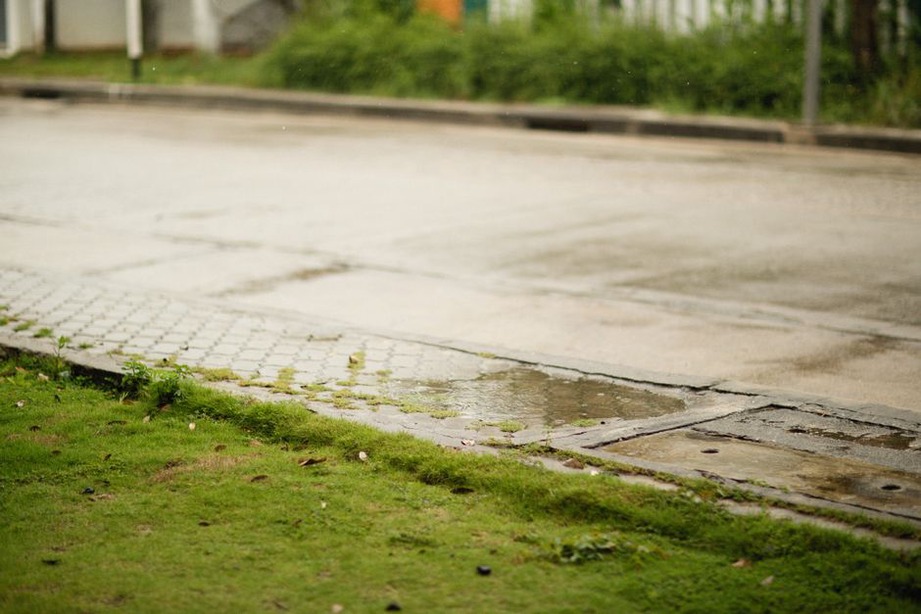 Surface runoff moving along a roadside channel