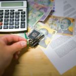 Lease documents beside a list of housing costs