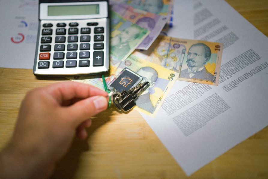 Lease documents beside a list of housing costs